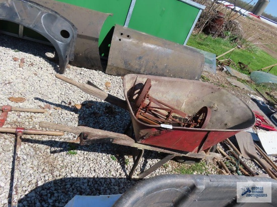 Antique wheelbarrow with pneumatic wheel and reel mower parts