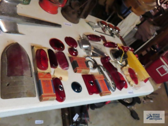 New Old Stock tail lamp lenses, license plate light, and other vintage automotive parts