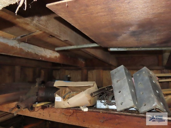 Assorted automotive parts, hardware, mufflers, heavy duty aluminum brackets on shelf