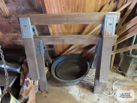 Wooden saw horses, pneumatic hose, drop light, wooden slats, wood cutoffs, adjustable baby gate