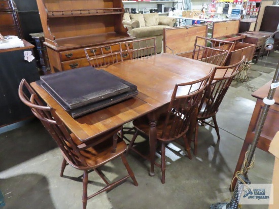 Sterling House drop leaf table with six chairs and open top cherry hutch. One of the fold-out legs