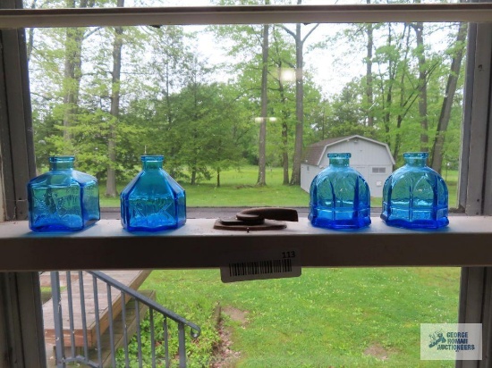 Four aqua bottles marked Wheaton, New Jersey