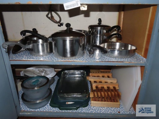 Cupboard lot of Farberware pots and pans and refrigerator dishes. Baking glassware. Shelf divider.