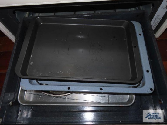 Trays and ovenware in drawer of oven