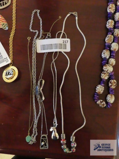 Silver colored costume jewelry necklaces