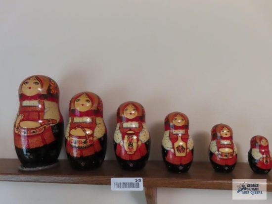 Marked seven piece girl in red dress nesting doll set