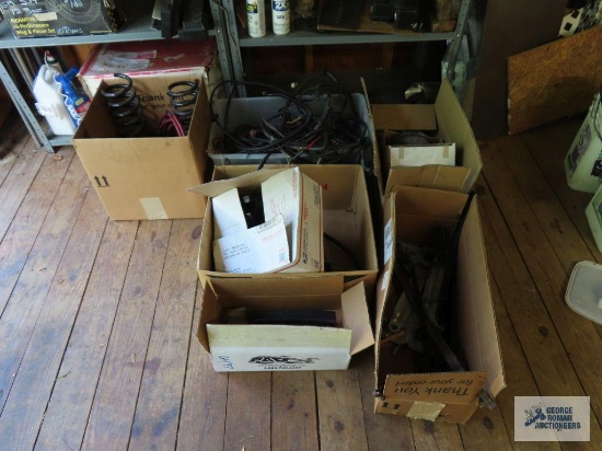 Lot of used automotive parts and wiring, rope, and hardware on shelving. Metal shelving not