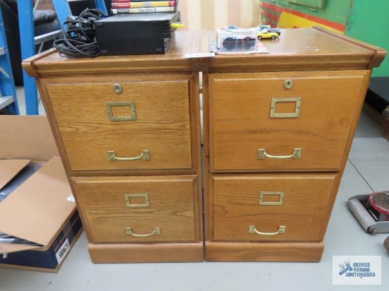 Two wooden filing cabinets with keys. In garage.
