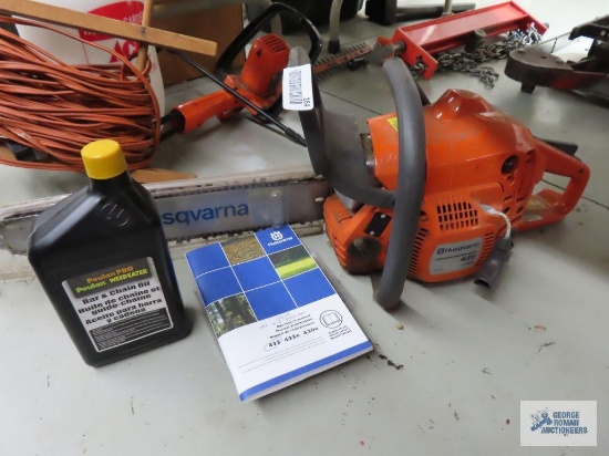 Husqvarna 435 chainsaw with partial full bar and chain oil, operators manual, and 16" chain in