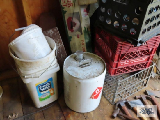 Barrel pumps, milk crates, tent pieces, tire thumper, hand pruner, and PVC pieces in corner