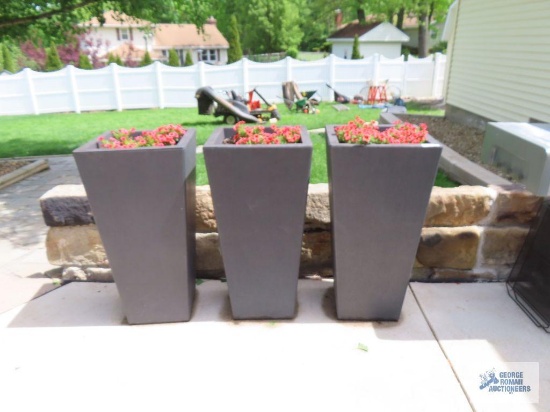 Five 3 ft tall heavy planters with live flowers. Buyer must take potting soil and or dirt with them!