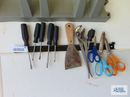 Screwdrivers, pliers, scraper, and scissors with magnetic wall mounts
