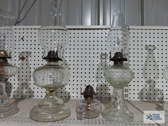Three assorted glass oil lamps