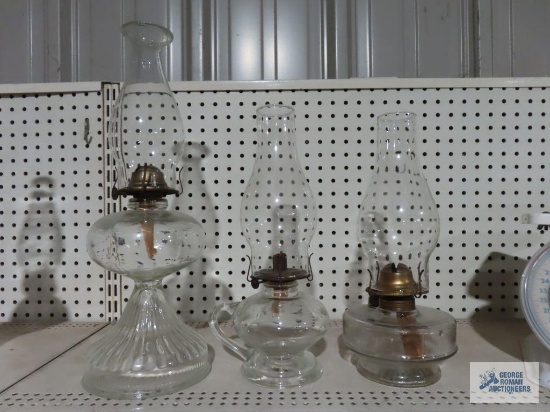Three glass oil lamps.
