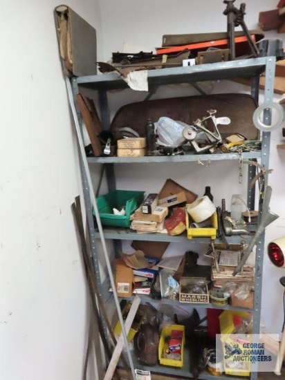 Metal shelving unit with contents, including Acme Key Co. manual key cutter, various automotive