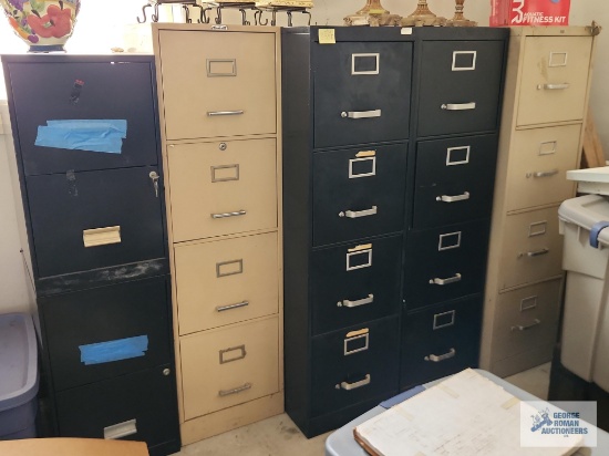 Five assorted metal filing cabinets in garage. Only one key included to the black cabinet on the far