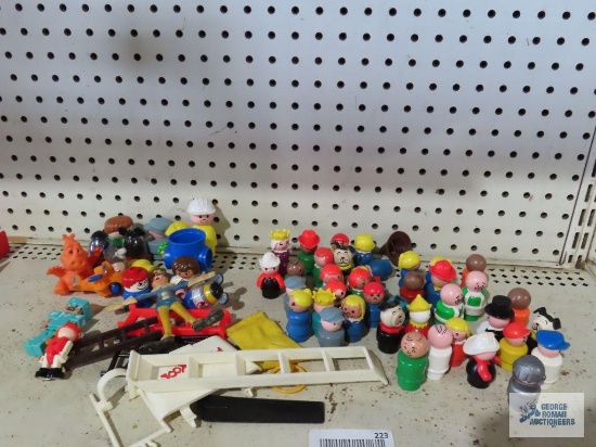 A variety of little people figurines, Fisher Price figurines, and others