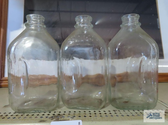 Three glass half gallon milk bottles