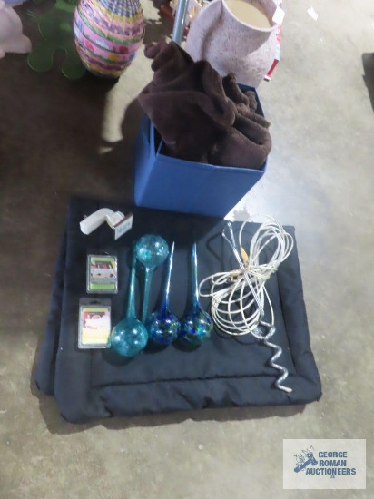 Dog cage pad, plant waterers, candles, dog tie out, throw blanket, and folding boxes