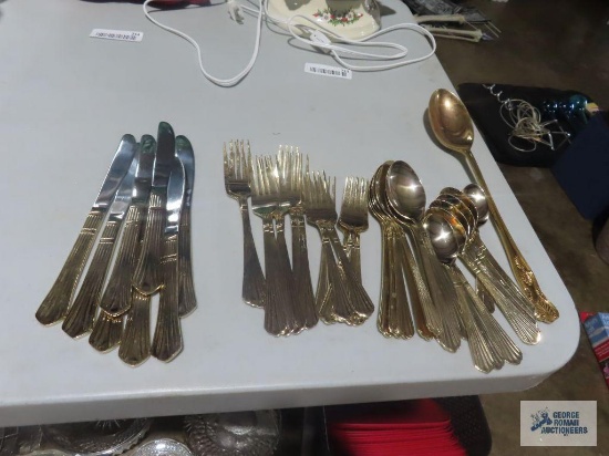 Stainless steel gold colored flatware service for 8 and gold colored serving spoon