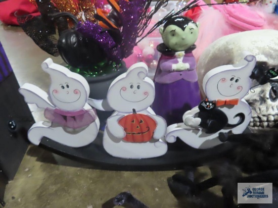 Halloween decorations, including skulls, spiders, signs, poison bottles, books