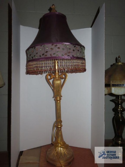 Gold tone resin lamp with purple bead fringe shade, approximately 35".