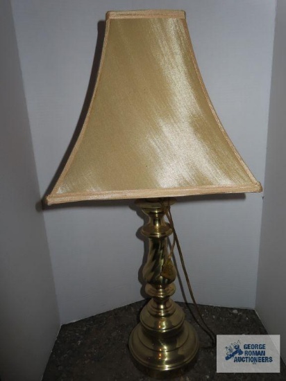 Brass base lamp with tan shade, approximately 28".