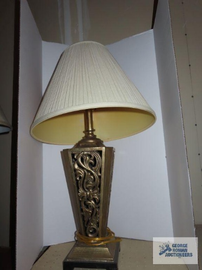 Plastic cutout base lamp with cream colored shade approximately 31".