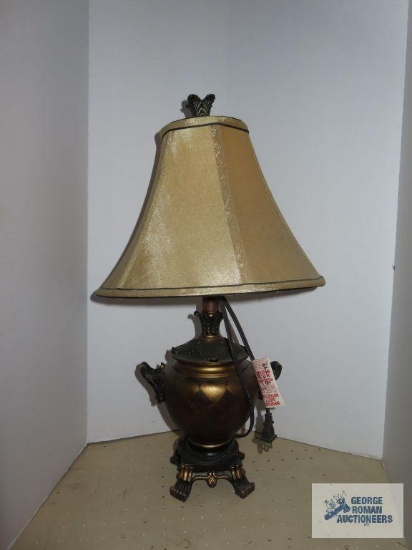 Plastic urn lamp with geometric patterns and handles and brown shade, approximately 23".