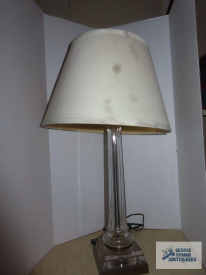 Metal, plastic, and glass lamp with cream colored shade. approximately 27".
