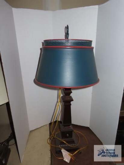 Bronze colored heavy metal base lamp with blue and red tin shade approximately 31".