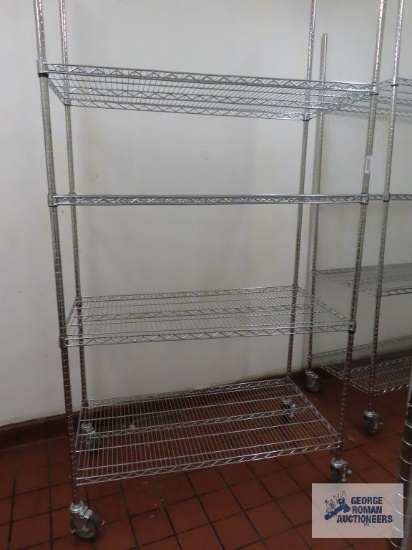 Stainless steel roll about adjustable rack made by Olympic Storage Products. 4' x 2' x 7' 8". Rack