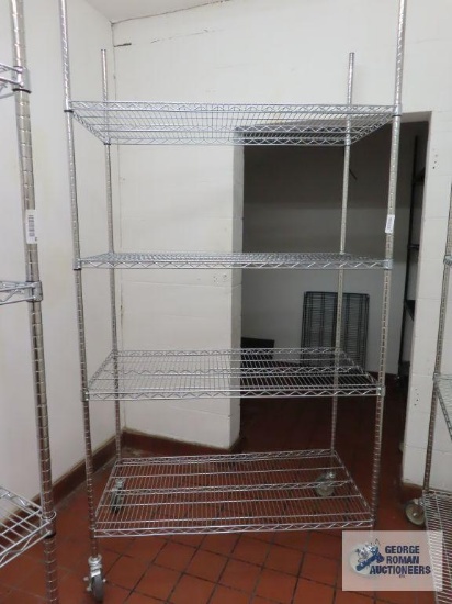 Stainless steel roll about adjustable rack made by Olympic Storage Products. 4' x 2' x 7' 8". Rack