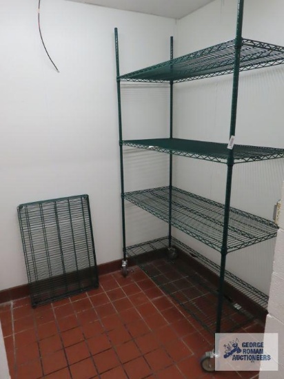 Green metal roll about adjustable rack. 4' x 2' x 7' 8". Rack will either have to be taken apart or