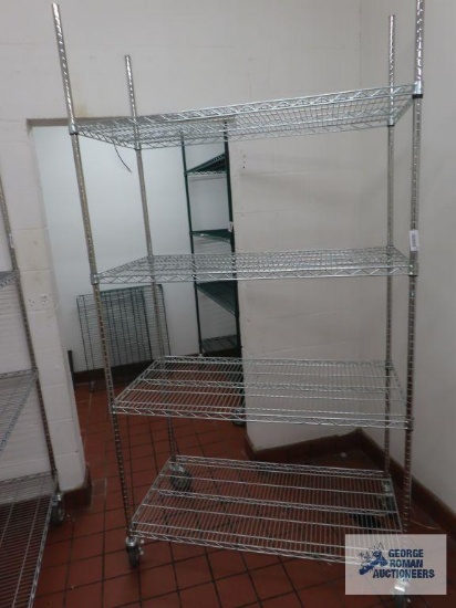 Stainless steel roll about adjustable rack made by Olympic Storage Products. 4' x 2' x 7' 8". Rack