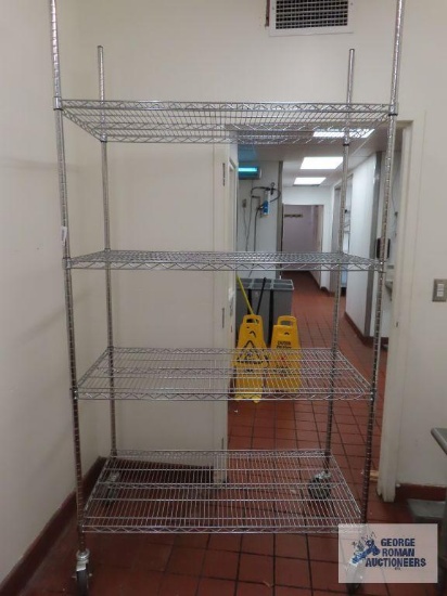 Stainless steel roll about adjustable rack made by Olympic Storage Products. 4' x 2' x 7' 8". Rack