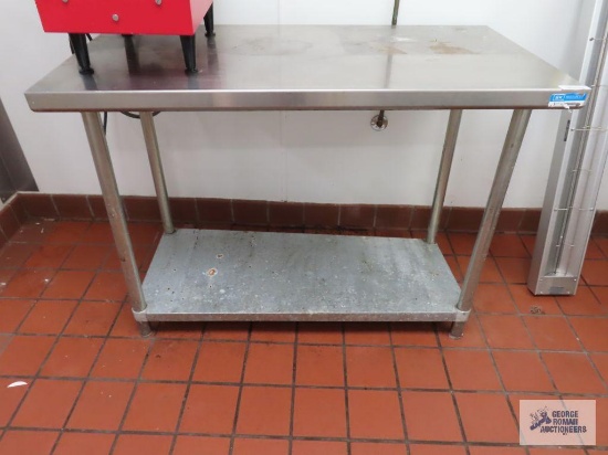 Stainless steel table. 4' x 2' x 34".
