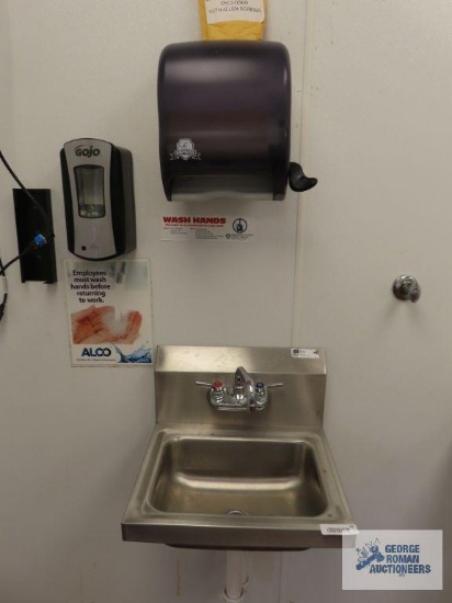John Boos stainless steel hand washing sink with paper towel dispenser and soap dispenser. Sink is