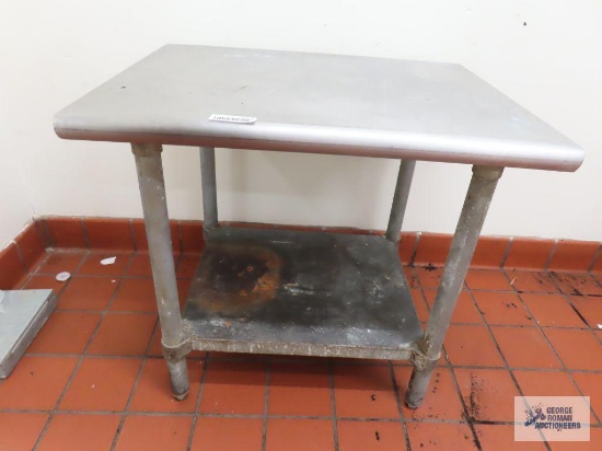 Stainless steel table. 2' 6" x 23-1/2" x 28".