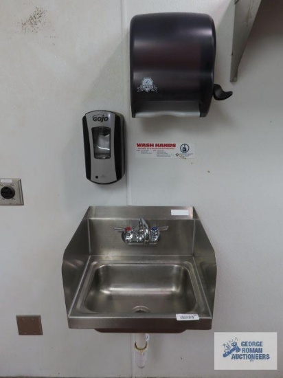 Hand washing sink with paper towel dispenser and soap dispenser. Sink is 17" x 16" x 10". Bring
