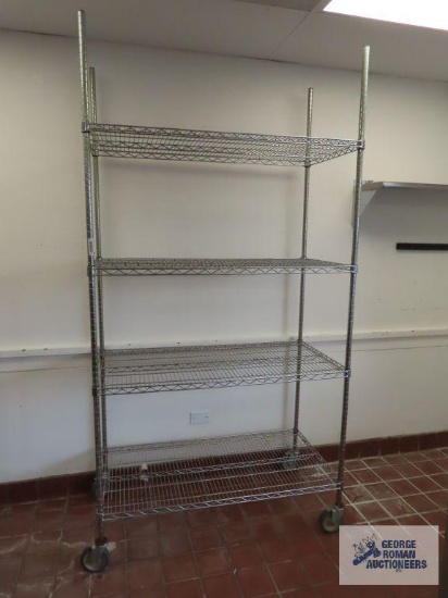 Stainless steel roll about adjustable rack made by Olympic Storage Products. 4' x 2' x 7' 8". This