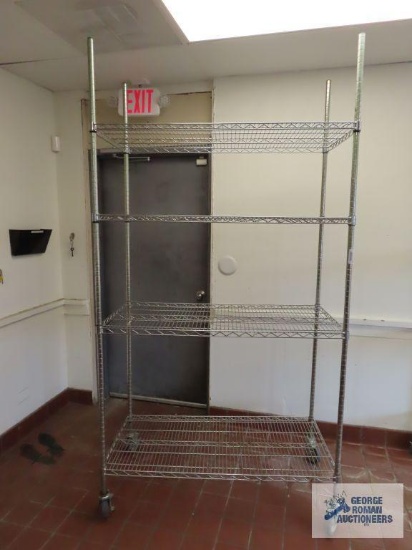 Stainless steel roll about adjustable rack made by Olympic Storage Products. 4' x 2' x 7' 8". This