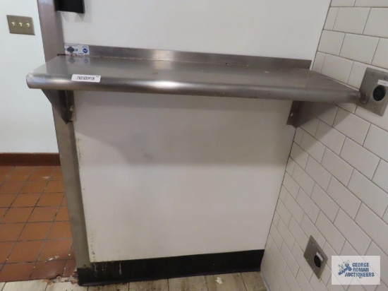 Stainless steel wall shelf. 3' x 12". Buyer to remove from wall.