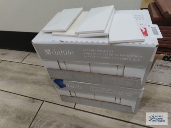 Two boxes of Daltile 3" x 6" white ceramic wall tile with five extra pieces. Approximately 100 pcs