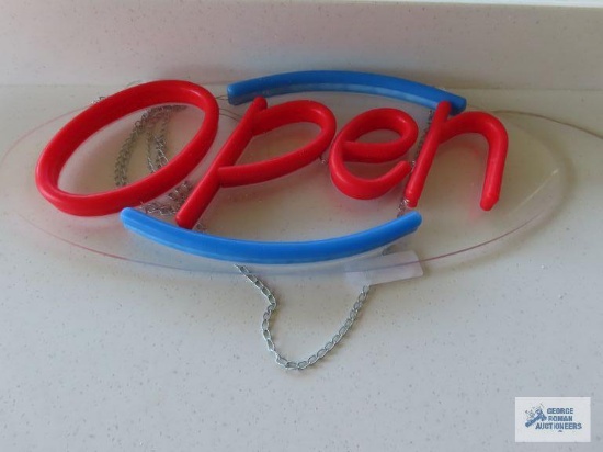 Two lighted Open signs made by Uprite Electronic Co.