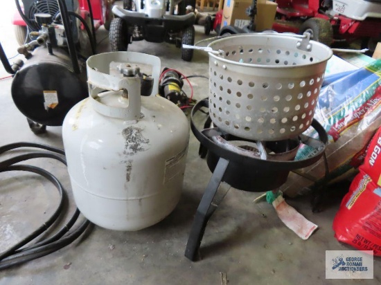 Turkey fryer basket with empty propane tank and burner