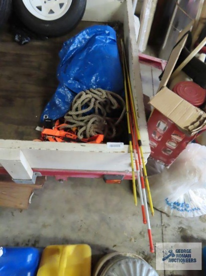 Driveway markers, ratchet strap, rope, and tarp.