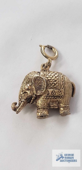 Gold tone / brass finish elephant pendant resembling a decorative charm or mid-century figural