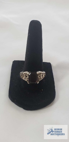 Sterling silver ring with filigree style band and a deep brown rectangular amethyst or garnet, size
