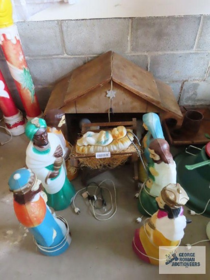 Lighted, weighted, plastic outdoor nativity set with seven figures and wooden manger. Standing